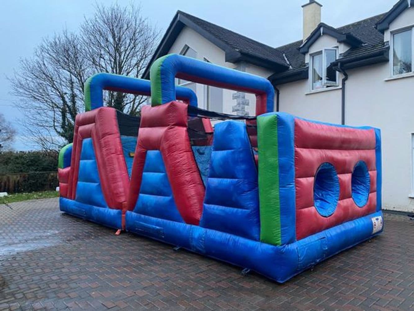 Sunshine Yellow bouncy castle on a Castlecraft weekend hire in a Wicklow garden.
